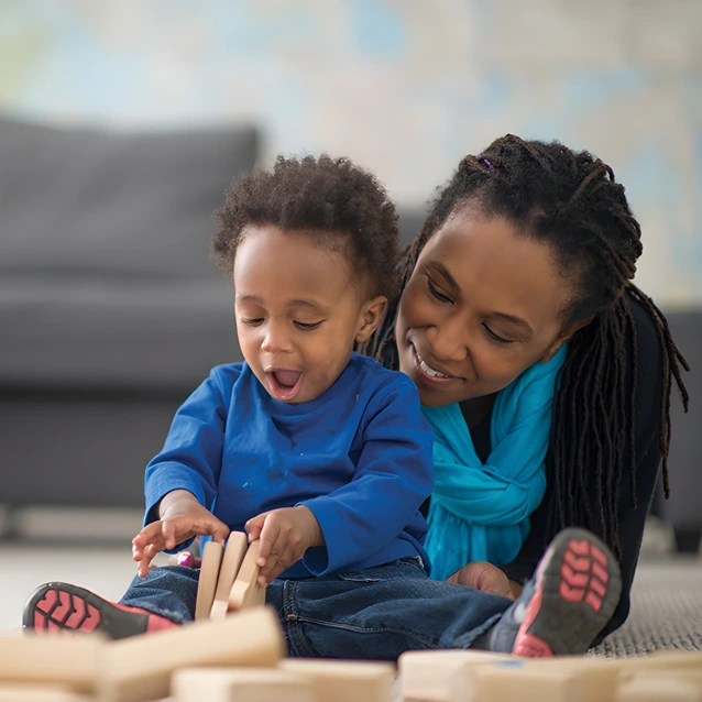 Mother and baby playing with wooden blocks