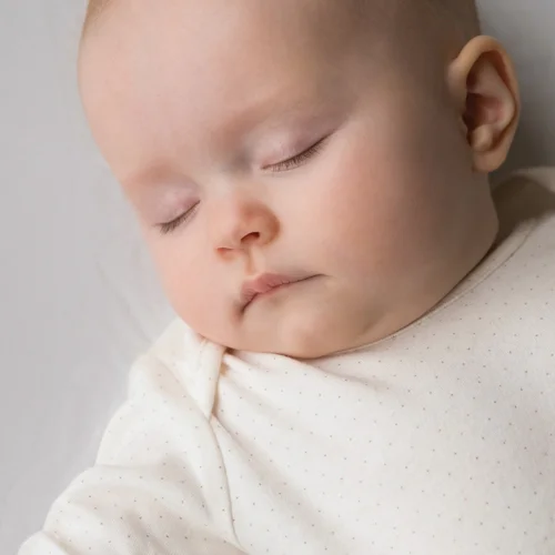 Sleeping baby peacefully resting in crib