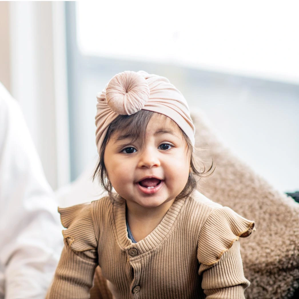 Smiling baby wearing a decorative headband