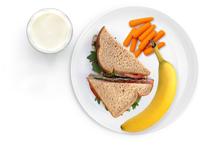 Sandwich, banana, carrots, and milk on plate