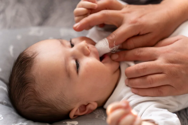 Babys gums gently cleaned with a soft cloth