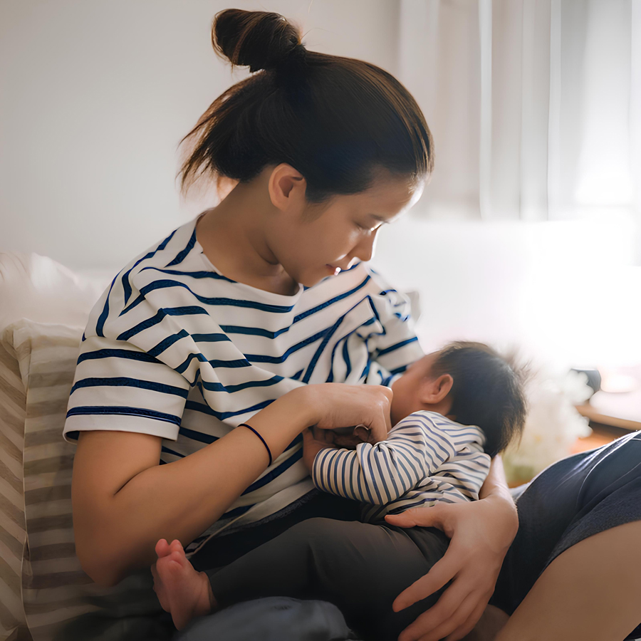 Mother breastfeeding baby in a cozy setting