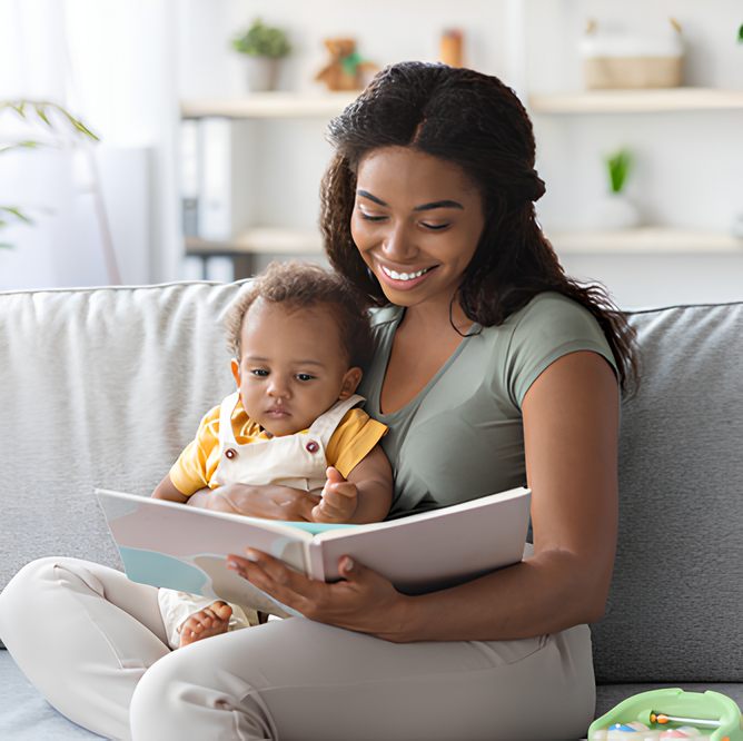 Mother reading to baby on the couch