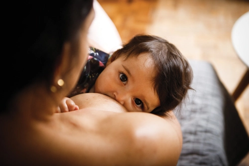 Mother breastfeeding baby in a calm setting