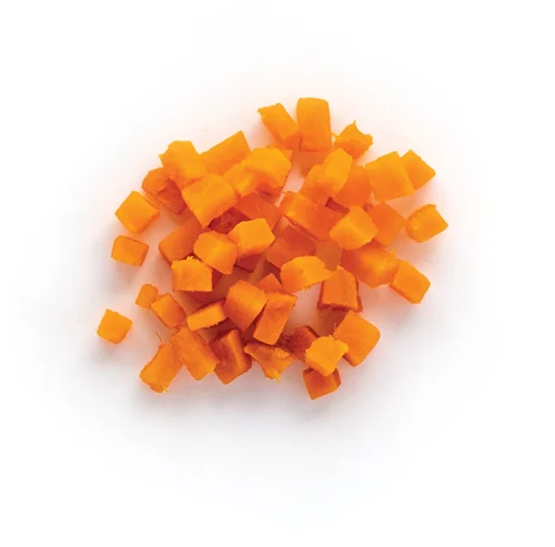 Diced sweet potato pieces scattered on white background