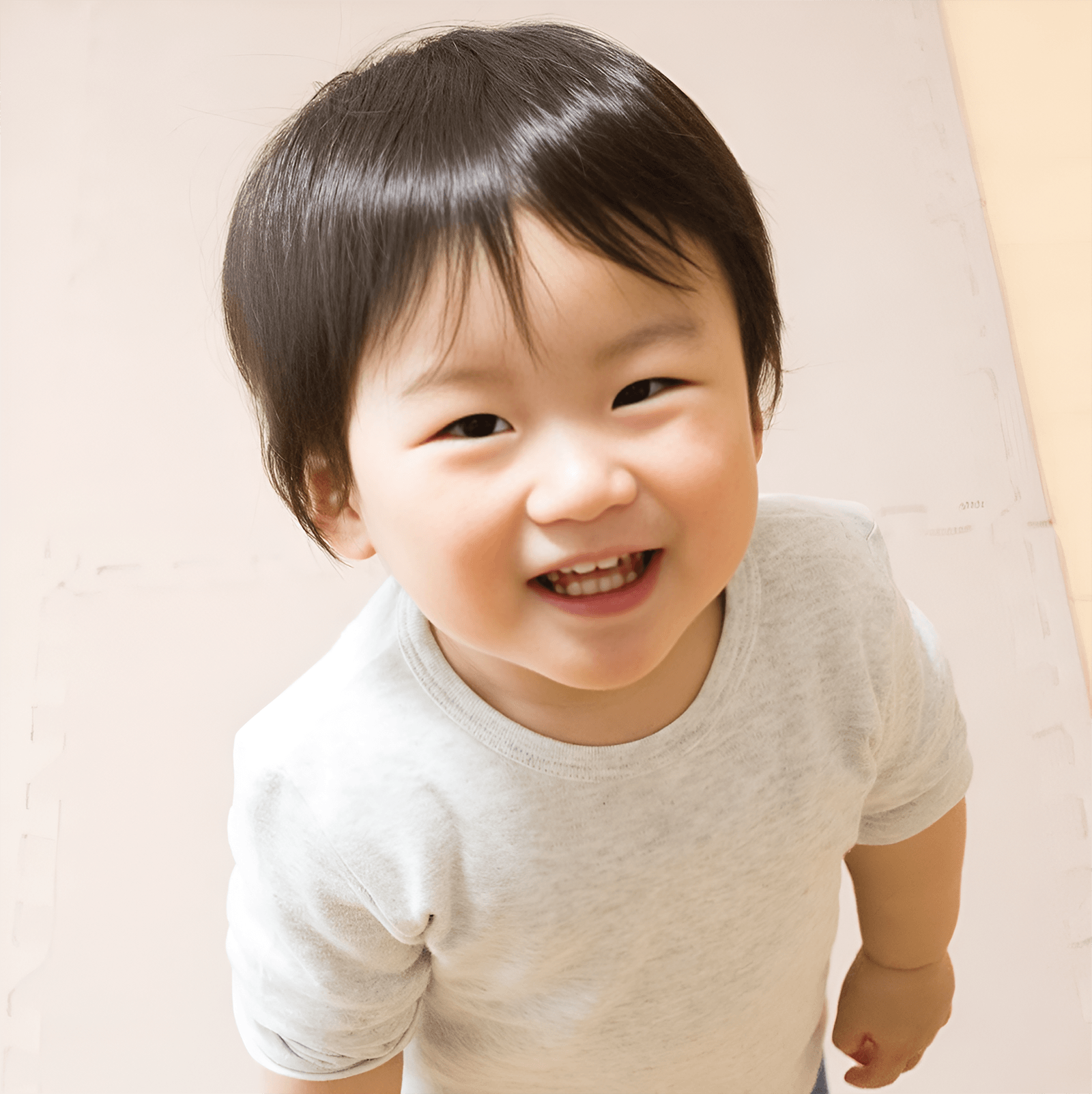 Smiling young boy standing indoors