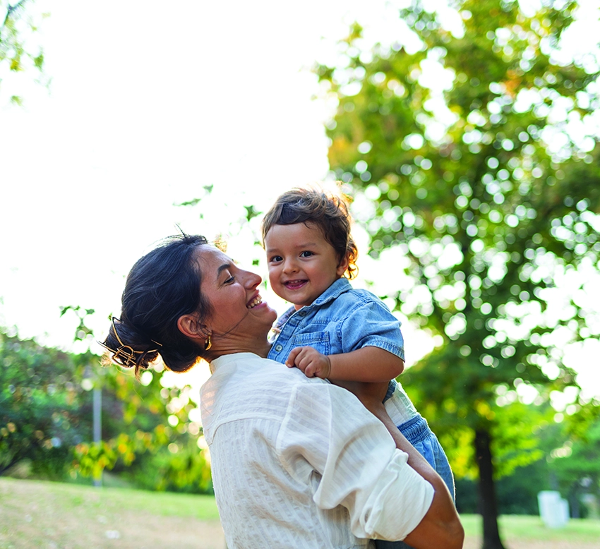 Mother and child smiling outside