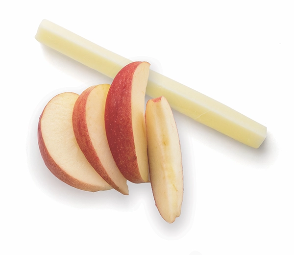 Sliced apple and string cheese on white background