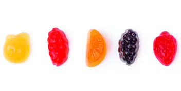 Colorful fruit-shaped snacks arranged in a row