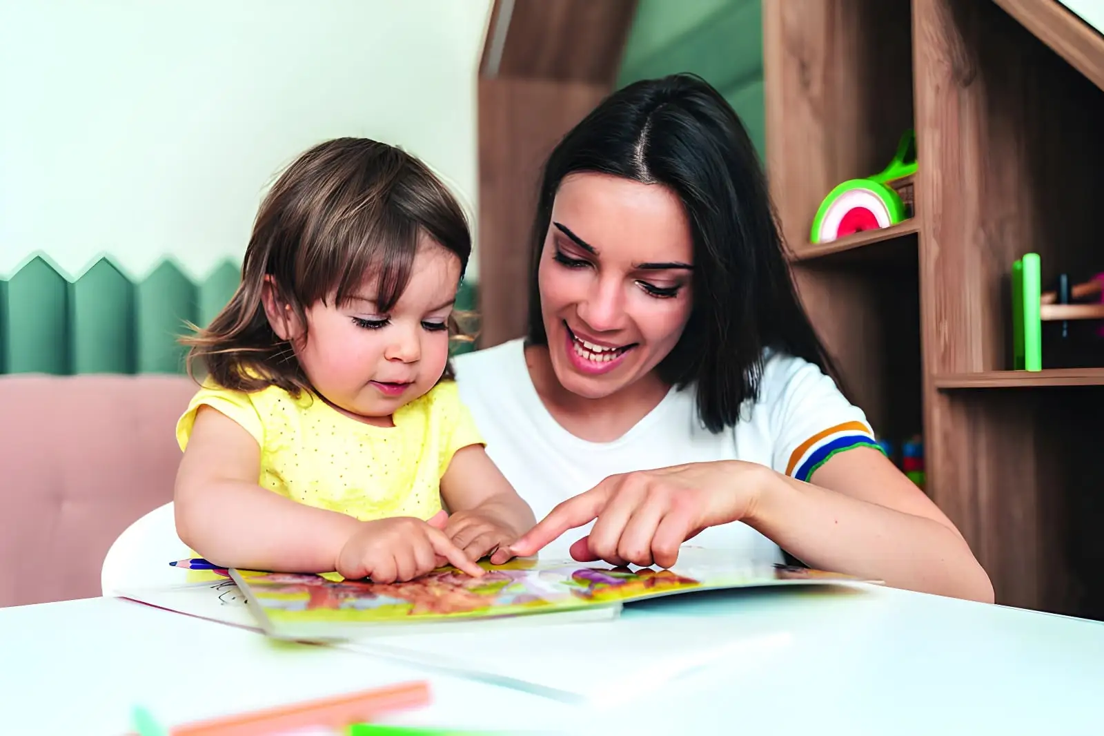 Mother and daughter reading a book together