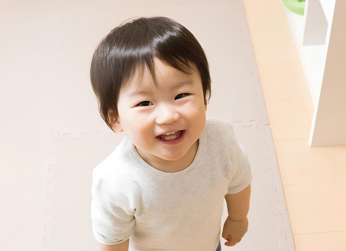 Smiling boy looking up warmly