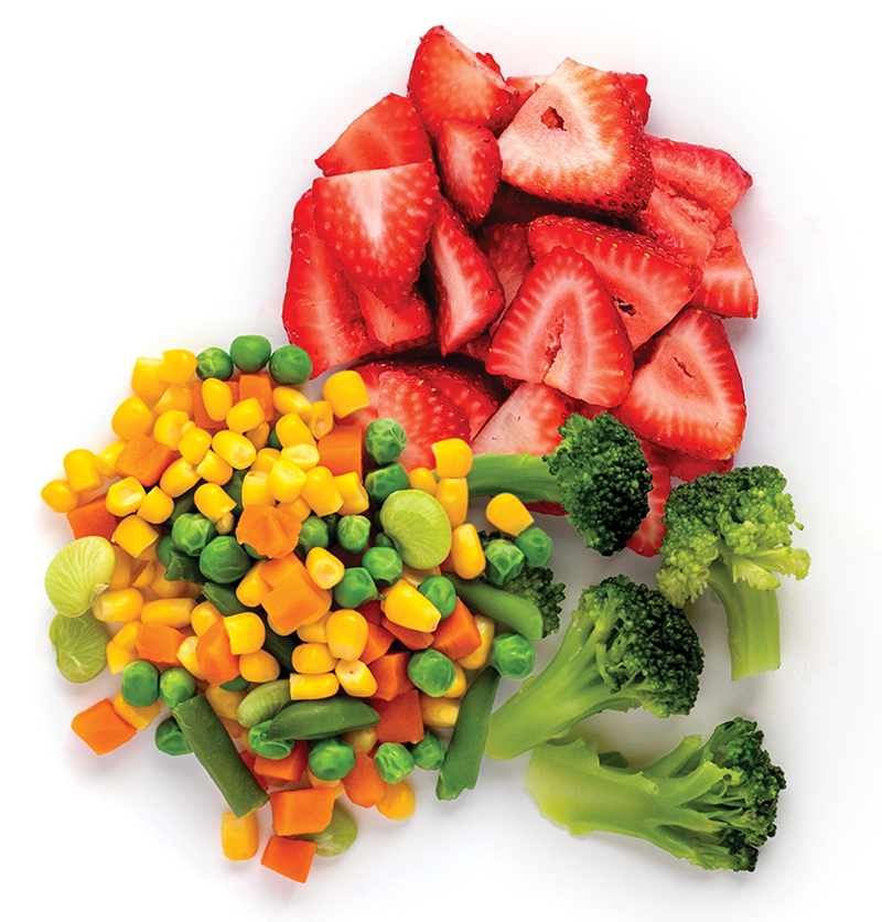 Fresh fruits and vegetables arranged on white surface